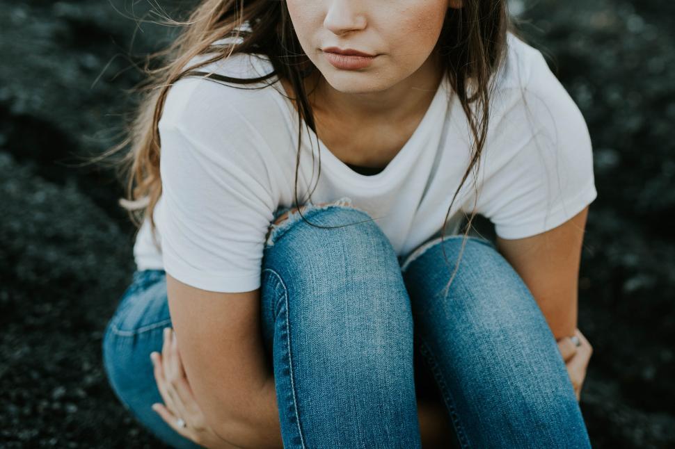 Free Image of A woman sitting on the ground 