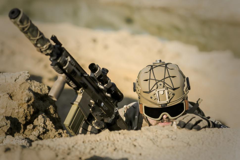 Free Image of A man in a helmet holding a gun 