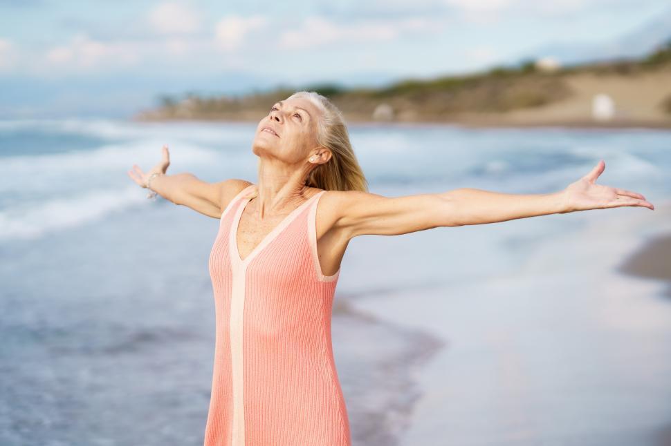Free Image of Elderly woman enjoying freedom at seaside 