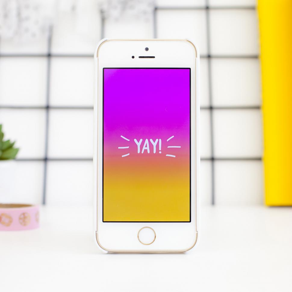 Free Image of A white cell phone with a purple screen 