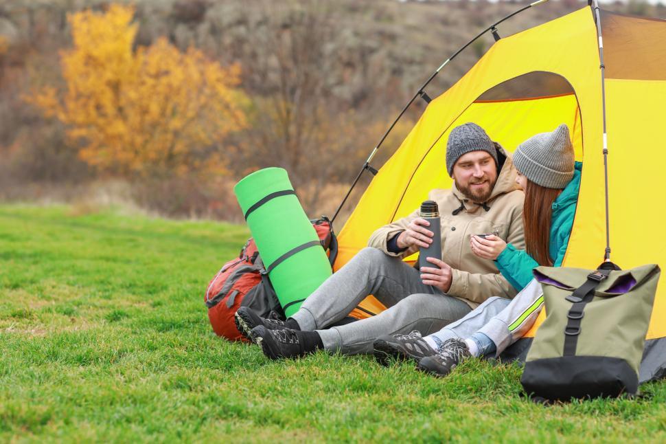 Free Image of A man and woman sitting in a tent 