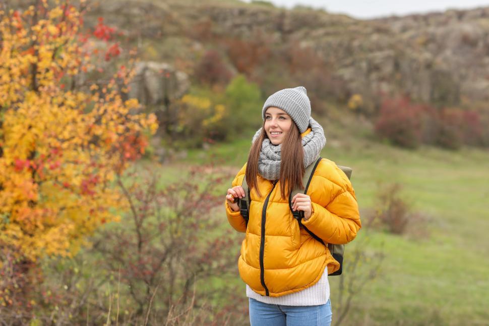 Free Image of A woman in a yellow jacket and hat 