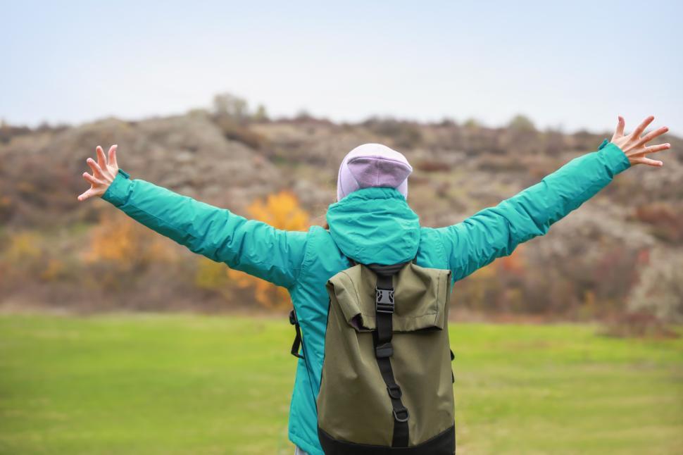 Free Image of A person with arms outstretched outside 