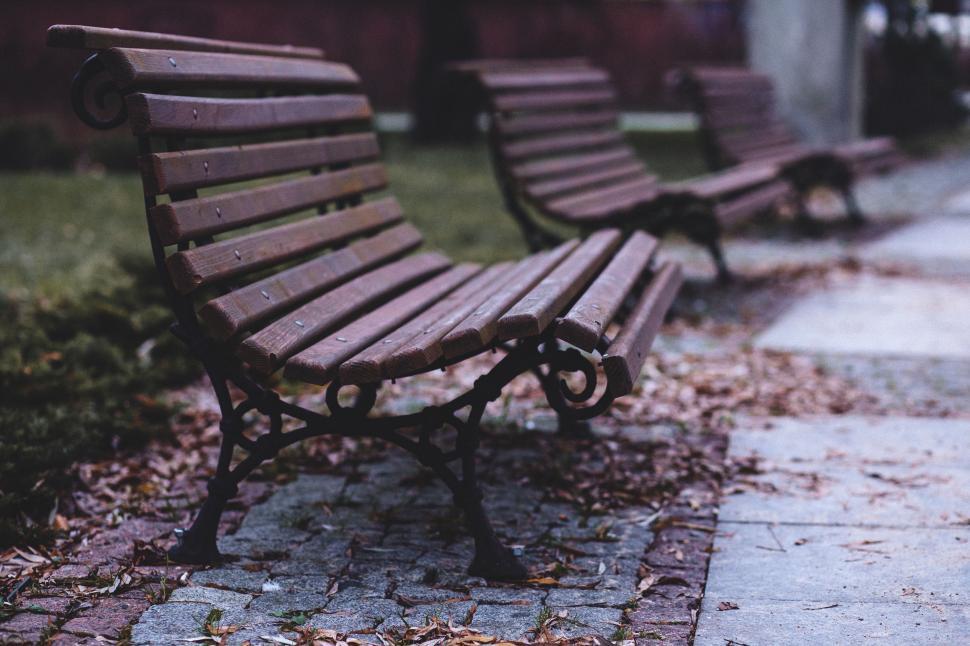 Free Image of A group of benches on a sidewalk 