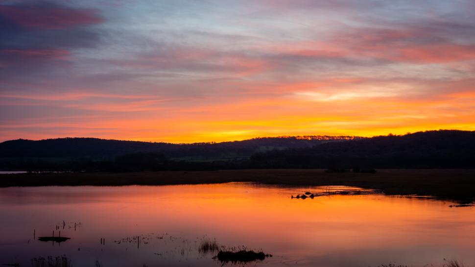 Free Image of A sunset over a lake 