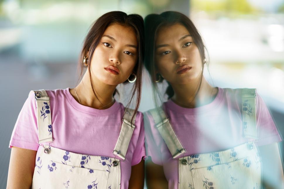 Free Image of Thoughtful upset Asian woman lost in thoughts outdoors. 