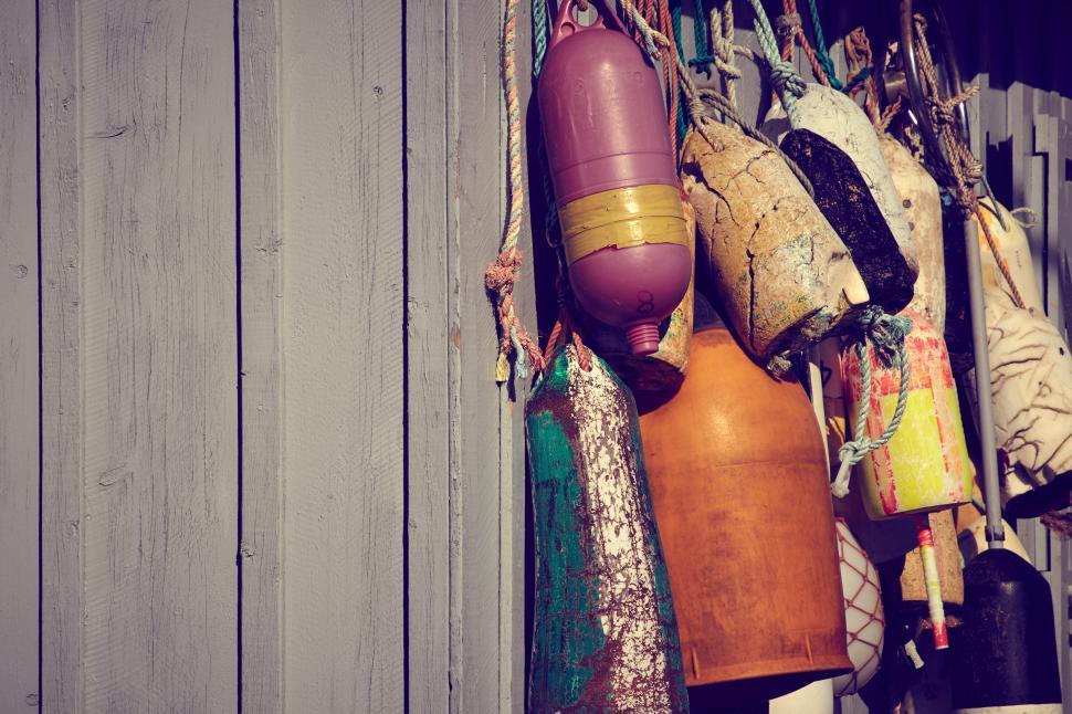Free Image of A group of buoys on a wall 