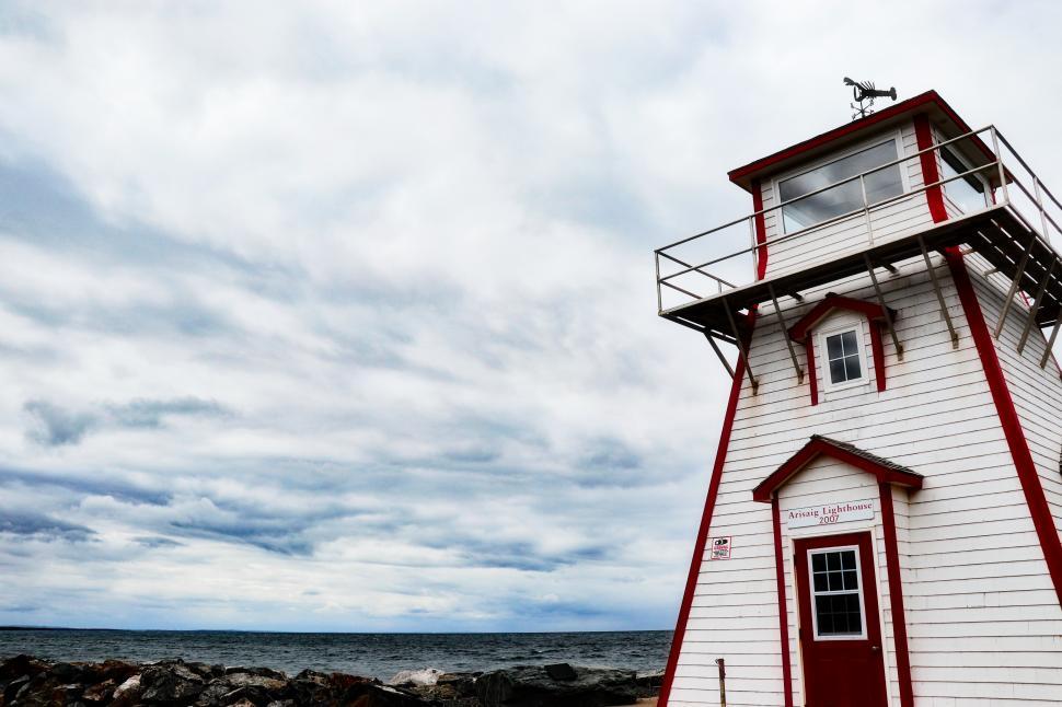 Free Image of A white and red building with a balcony on the side 
