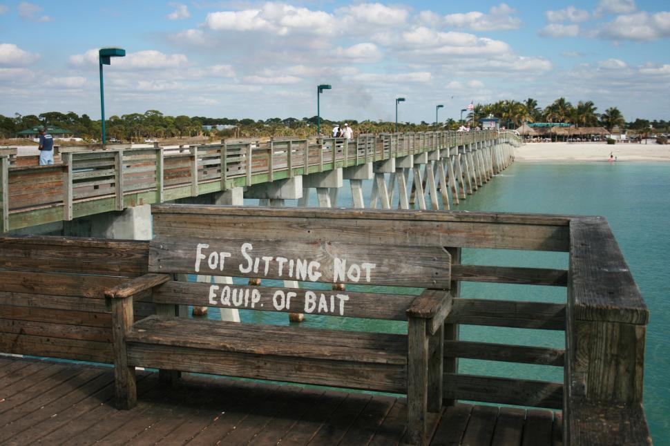 Free Image of A wooden bench with a sign on it 