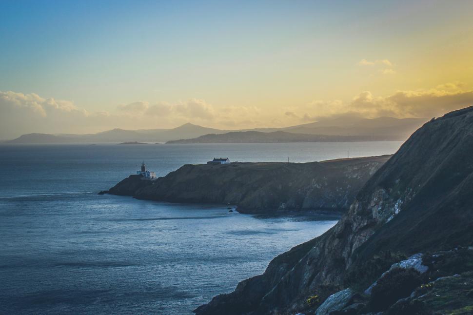 Free Image of A body of water with a lighthouse on it 