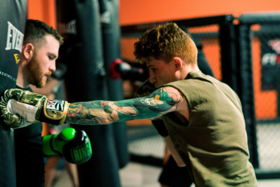 Free Image of A man punching a man with boxing gloves 