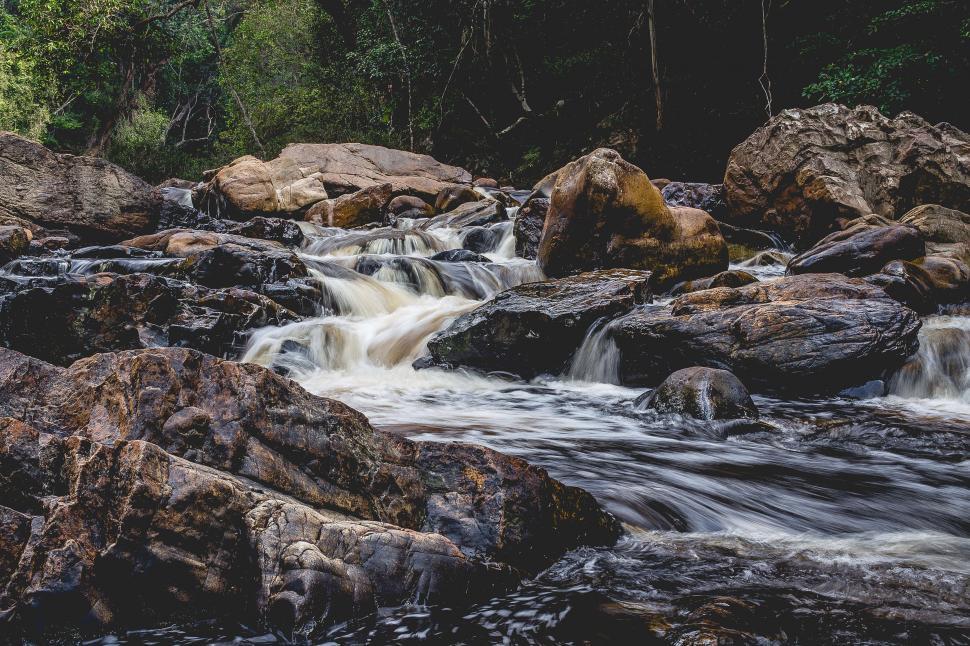 Free Image of A river flowing through rocks 