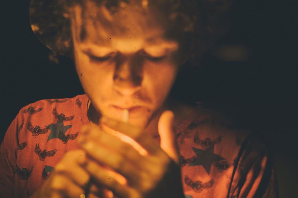 Free Image of A person lighting a cigarette 