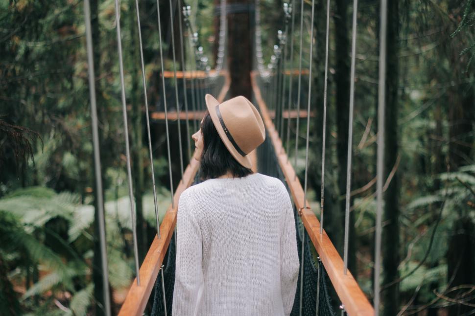 Free Image of A woman standing on a bridge 