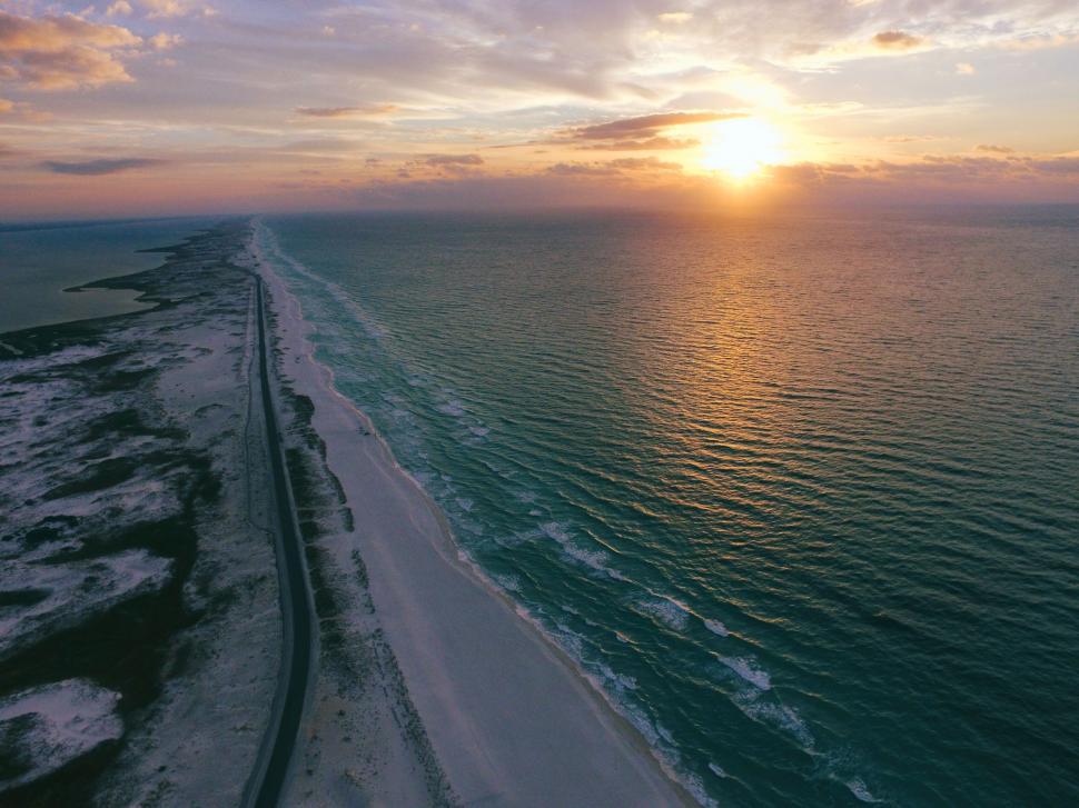 Free Image of A beach with a road and water 