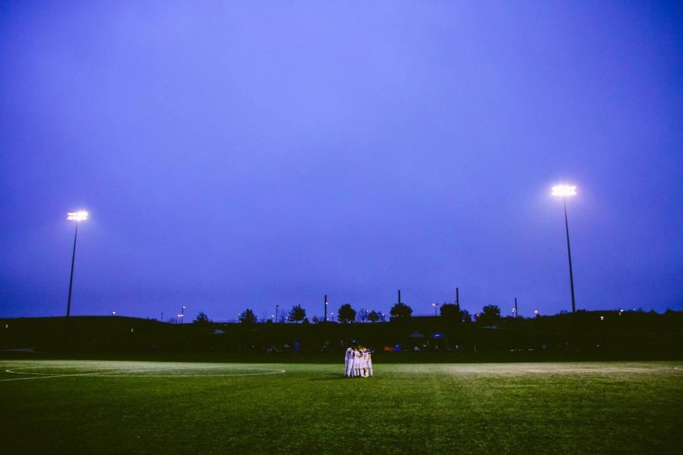 Free Image of A group of people standing on a field 