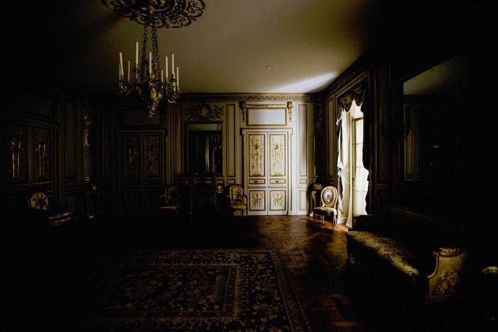 Free Image of A room with a chandelier and a couch 