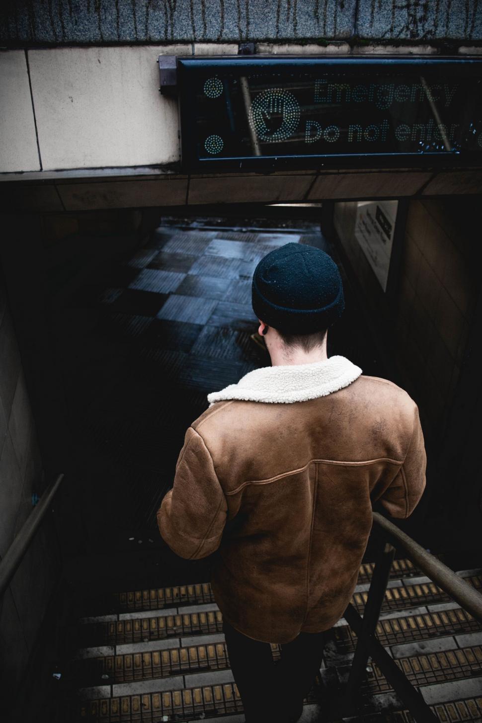 Free Image of A man standing on a staircase 