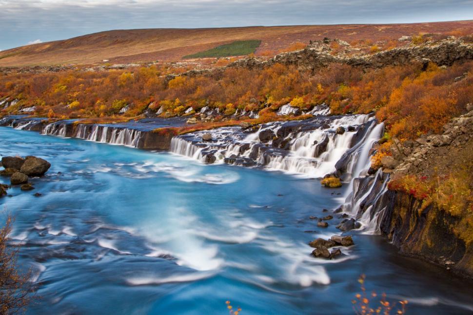 Free Image of A waterfall with rocks and trees 