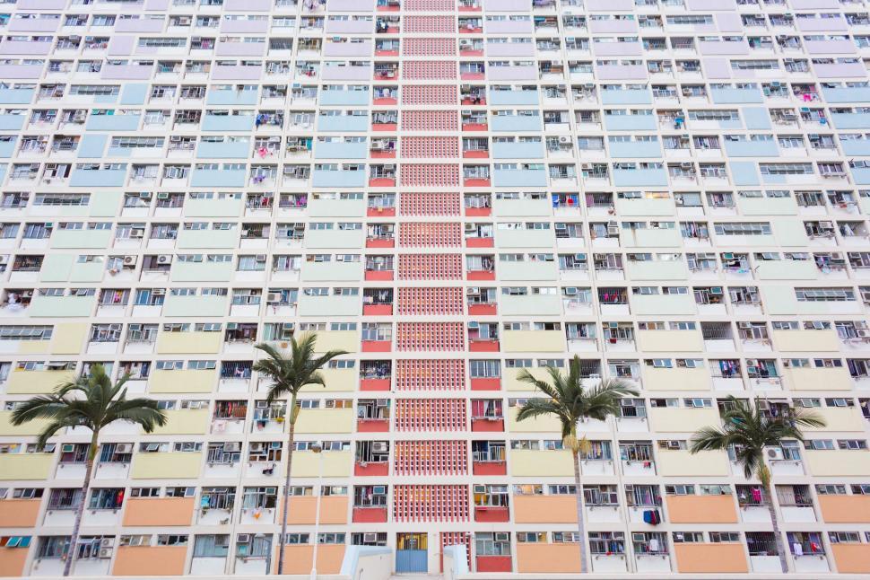 Free Image of A multi-story building with palm trees 