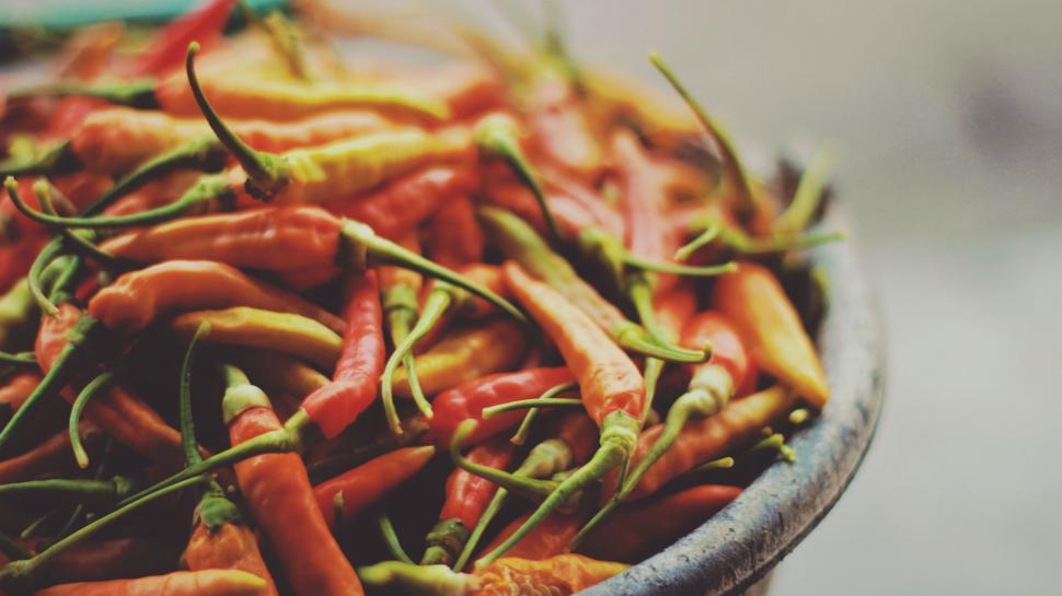 Free Image of A bowl of red and yellow peppers 