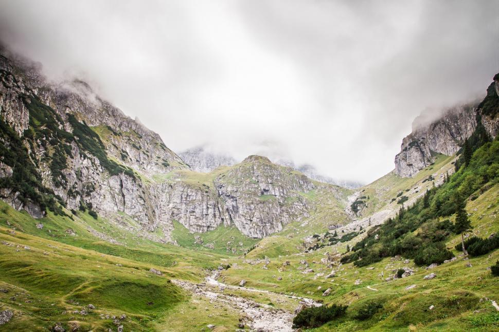 Free Image of A valley with rocky mountains and trees 