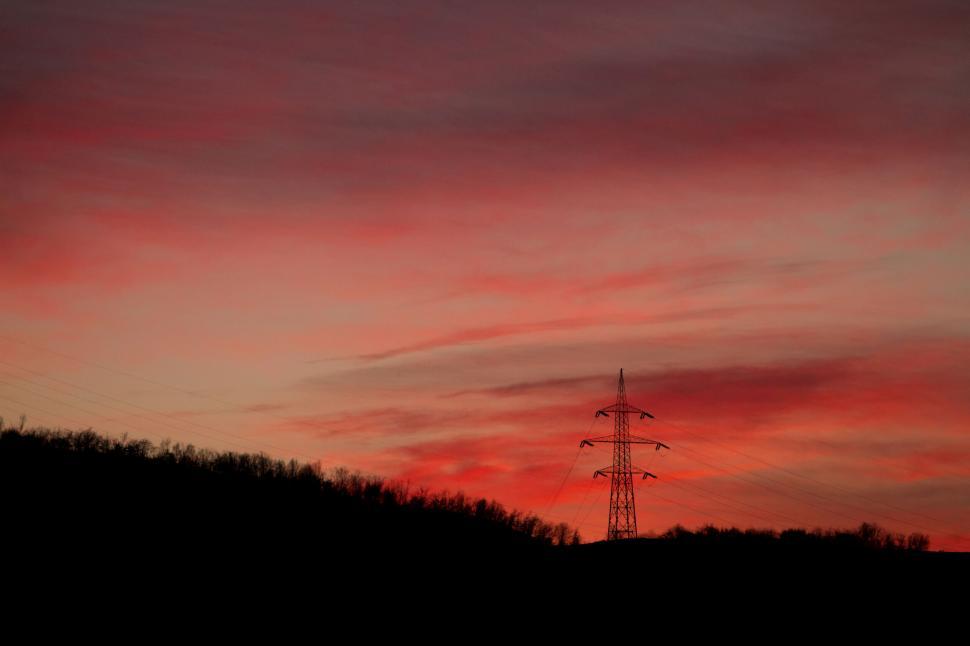 Free Image of A power line with trees in the background 