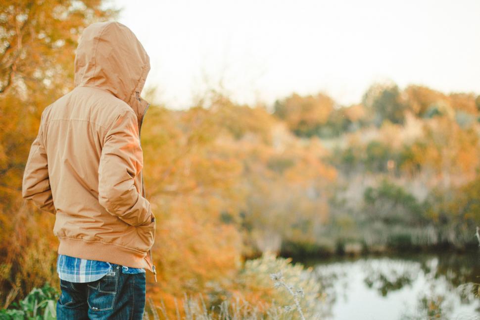 Free Image of A person standing in front of a body of water 