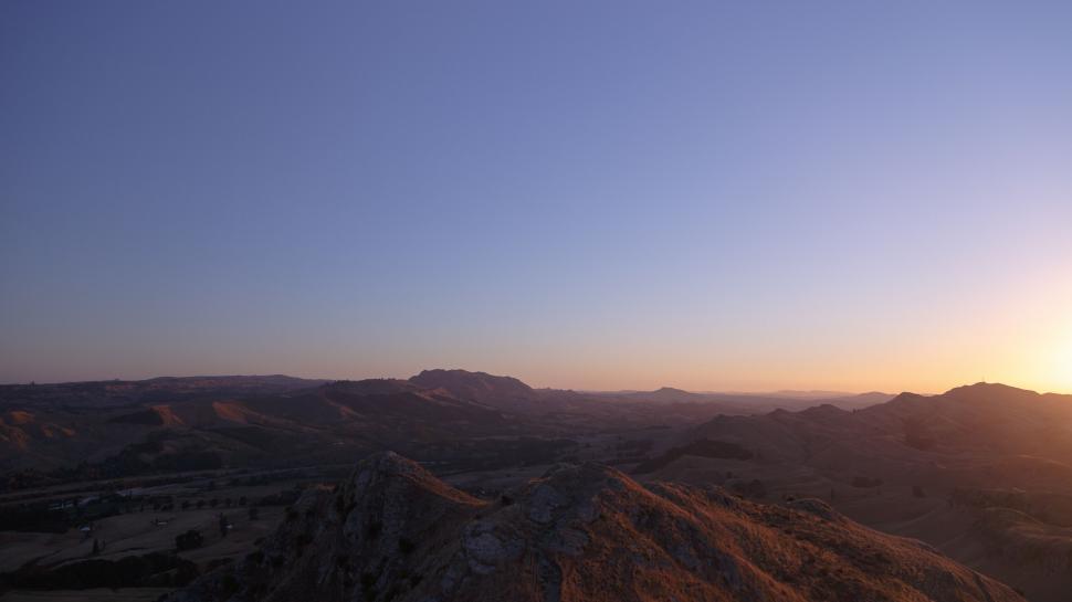 Free Image of A landscape of hills and a sunset 
