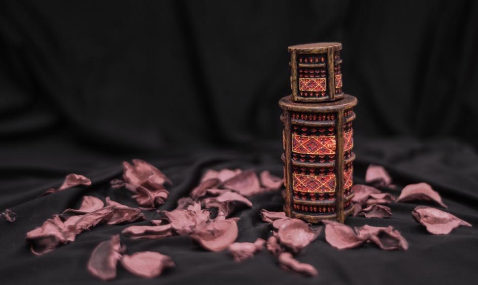 Free Image of A small decorative object with a red design on top of it 