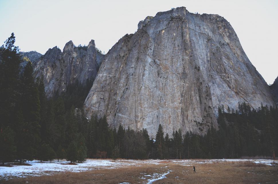 Free Image of A person standing in front of a large mountain 