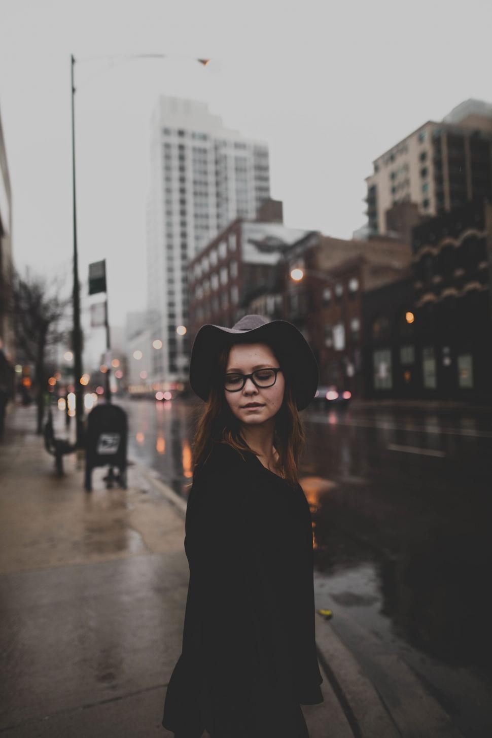 Free Image of A woman in a hat on a street 