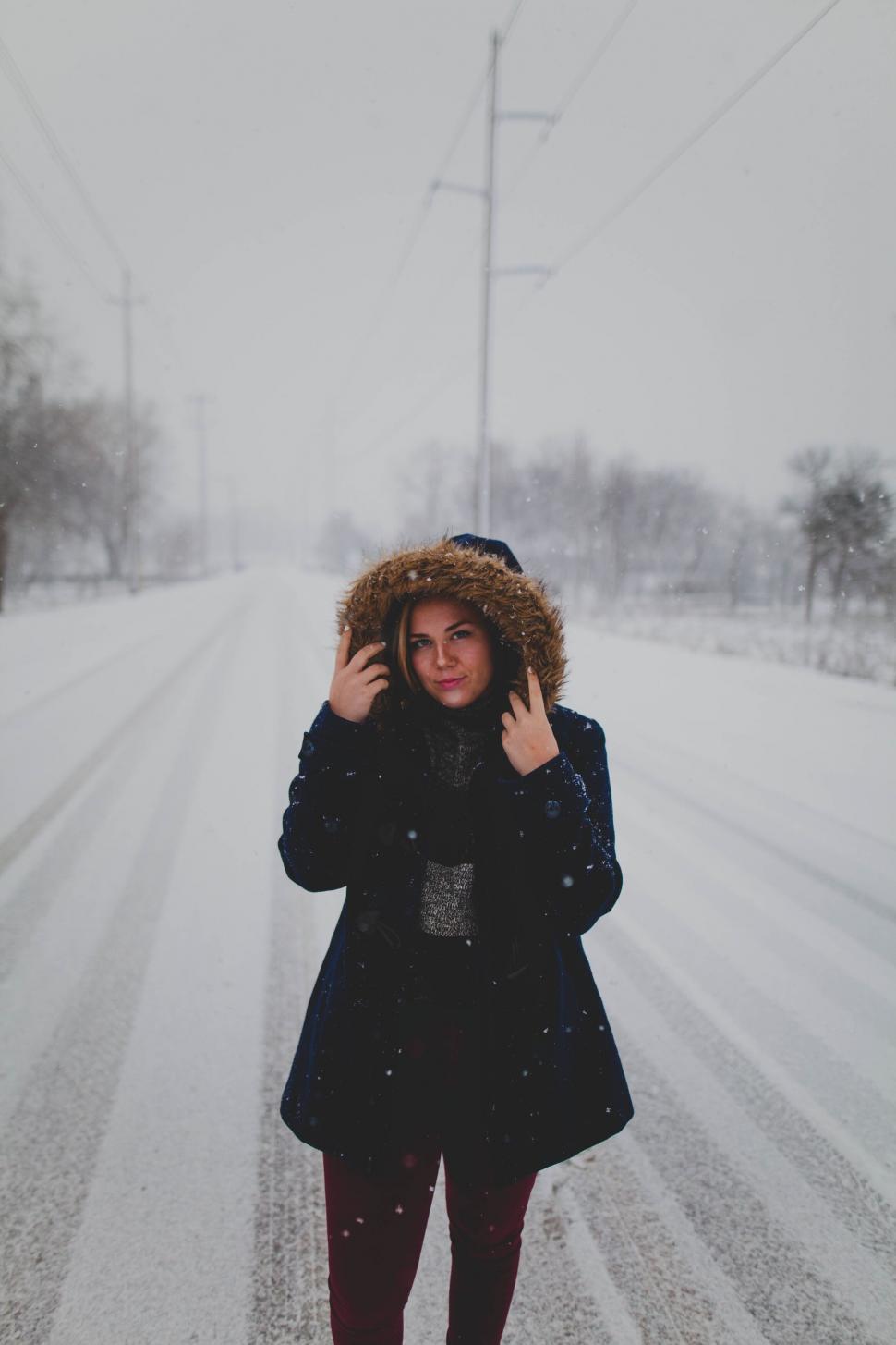 Free Image of A woman standing in the snow 