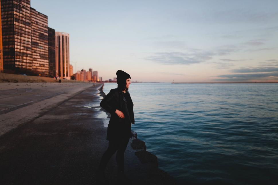 Free Image of A woman standing on a beach 