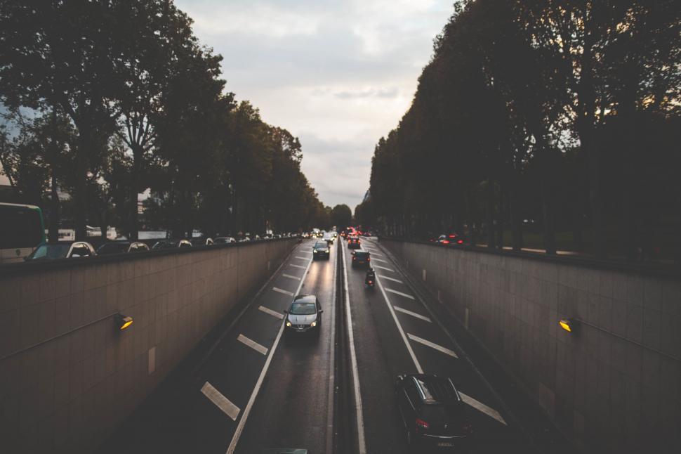 Free Image of A road with cars and trees 