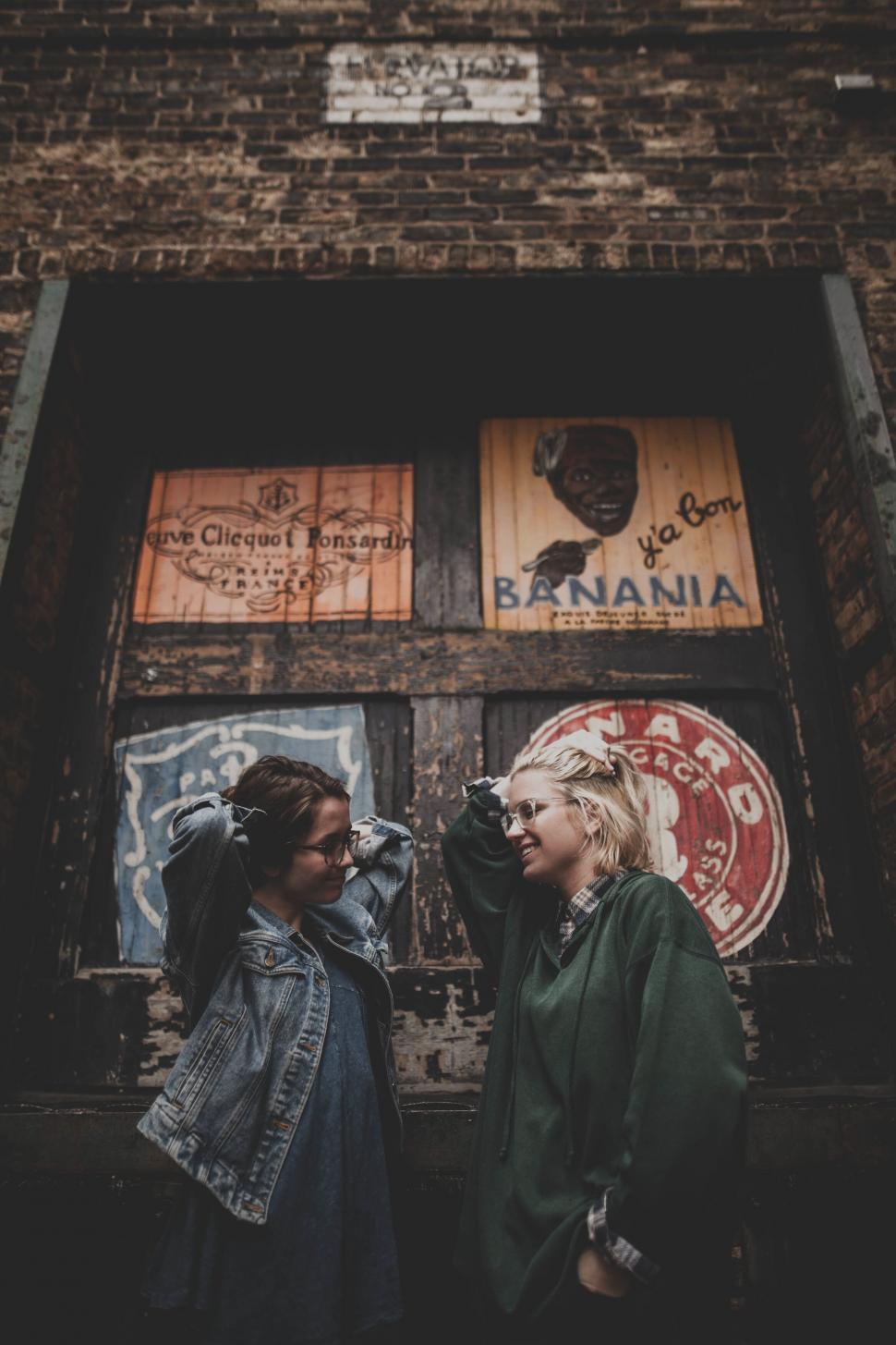 Free Image of Two women standing in front of a building 