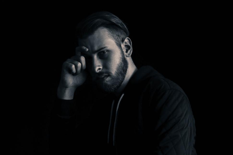 Free Image of A man with a hand on his face 