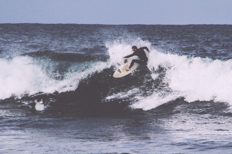 Free Image of A man surfing on a wave 