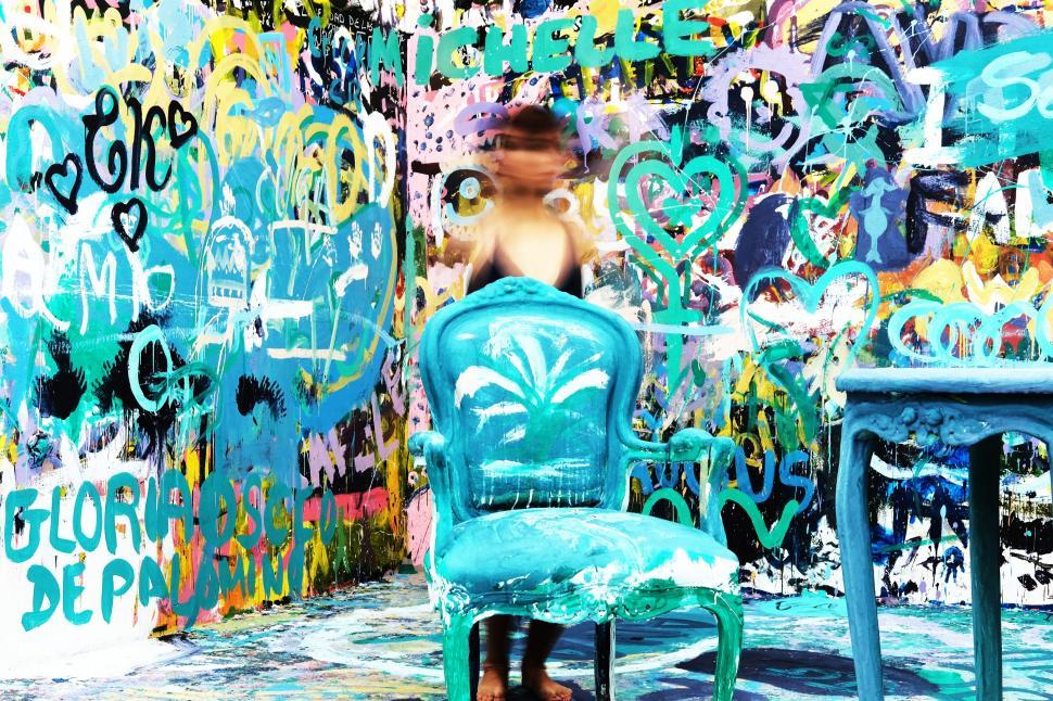 Free Image of A person standing in front of a chair 