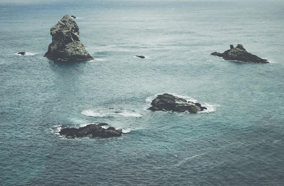 Free Image of A group of rocks in the water 