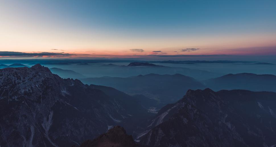 Free Image of A mountain range with clouds in the sky 