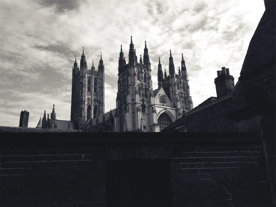 Free Image of A building with towers and a brick wall 