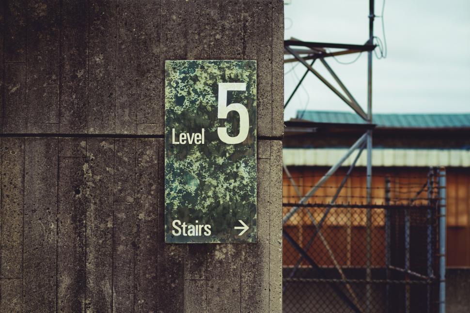 Free Image of A sign on a concrete pillar 