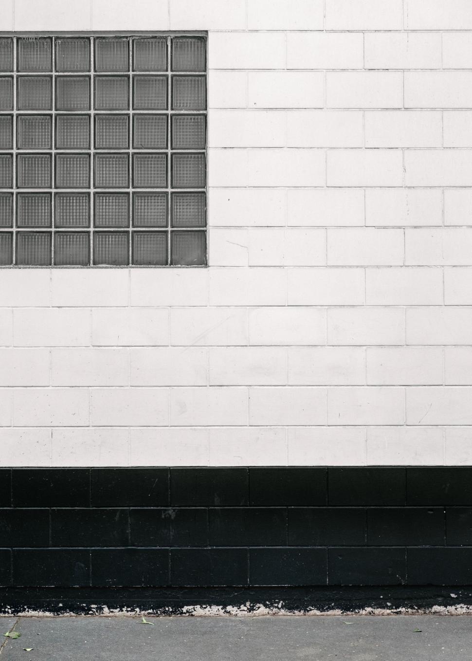 Free Image of Man Skateboarding Down Street by Building 