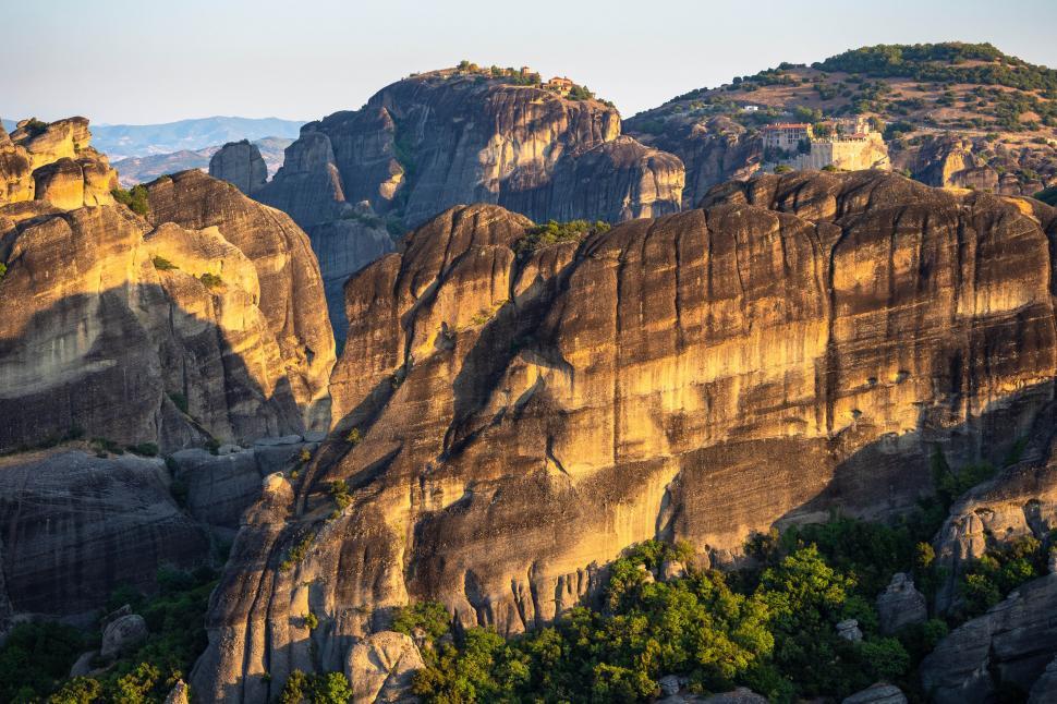 Free Image of A large rocky mountain with buildings on it 