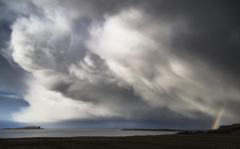 Free Image of A dark clouds over a body of water 