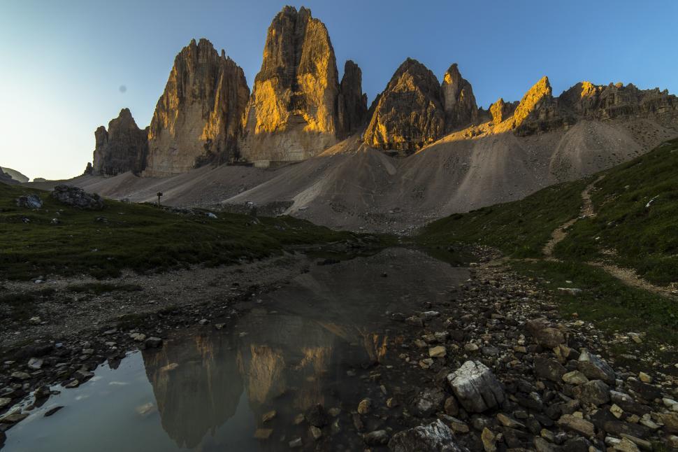 Free Image of A rocky mountains with a body of water 