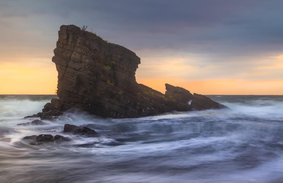 Free Image of A rock formation in the ocean 