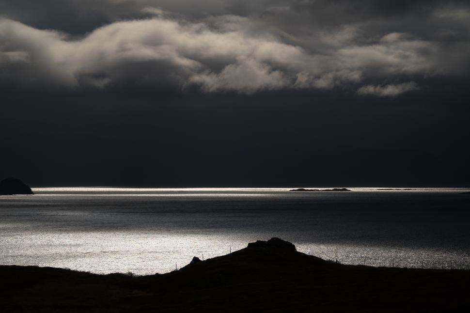Free Image of A dark sky over water 
