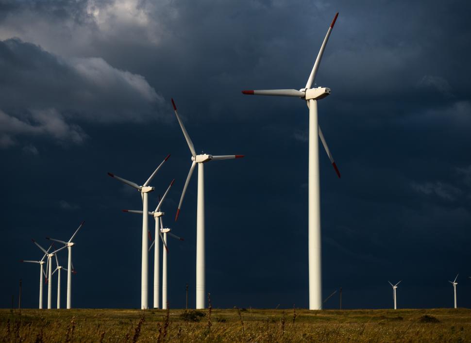Free Image of A group of windmills in a field 